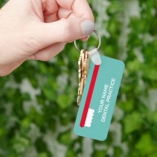 Tandarts kantoor sleutelhanger met rode tandenbors