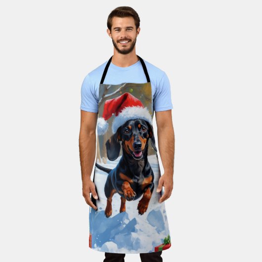 Teckel loopt in de sneeuw met kerst Pet Schort (Gedragen)