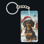Teckel Winter Wonderland Christmas Joy Sleutelhanger<br><div class="desc">Dit feestelijke ontwerp vangt de vrolijke sfeer van het vakantieseizoen, met een schattige pup die een kerstmuts draagt. De hond is genesteld in een winterwonderland, compleet met een sneeuwpop, een versierde kerstboom en prachtig ingepakte cadeaus. Sneeuwvlokken herfsten zachtjes en voegen een magische toets toe aan het tafereel, terwijl de levendige...</div>