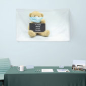 Teddy beer draag gezichtsmasker met handhanden spandoek (Beurs)