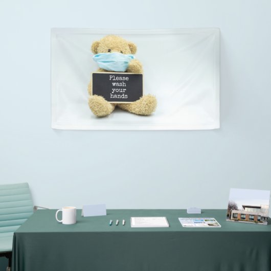 Teddy beer draag gezichtsmasker met handhanden spandoek (Beurs)