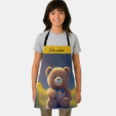 Teddybeer in een weide, schattig kinder schort (Insitu)