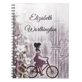 tekening van een jongedame op een fiets notitieboek