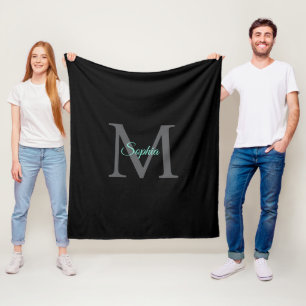 Teliaalschriftnaam, groot grijs monogram op zwart fleece deken