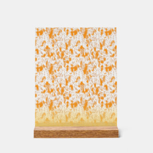 Textielpatroon met een levendig sinaasappel en gou acryl bord