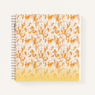 Textielpatroon met een levendig sinaasappel en gou notitieboek
