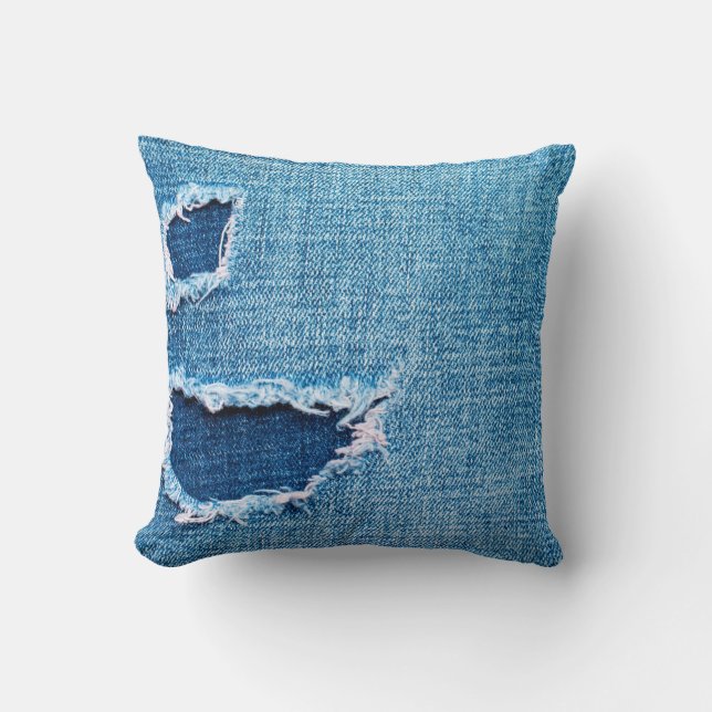 Textured denim background. Torn hole in the fabric Kussen (Voorkant)