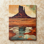 The Desert Monument Landscape Legpuzzel<br><div class="desc">This modern art jigsaw puzzle features an abstract rugged desert landscape in deep burnt red, orange, brown, teal, cream, and black. At the center rises a bold rocky butte reminiscent of the American Southwest, set against a dramatic sky and reflected in stylized water below. The artwork blends contemporary minimalism with...</div>