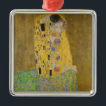 The Lovers Kissingembrace by Gustav Klimt Metalen Ornament<br><div class="desc">Het zonlicht schittert door de wervelende gouden omhelzing die de geliefden omringt in Gustav Klimts meesterwerk, The Kiss. De scène is een paradox van intimiteit en isolatie. Het paar staat op een afgrond, een veld van kleurrijke bloemen aan hun voeten, maar ze zijn zich niet bewust van de wereld om...</div>
