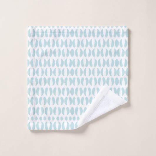 Towels with a light blue fish pattern hang neatly bad handdoek (Wasdoekje)