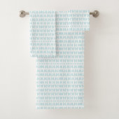 Towels with a light blue fish pattern hang neatly bad handdoek