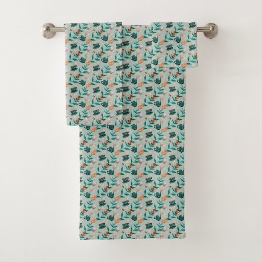 Towels with a teal floral pattern hang  bad handdoek (Insitu)