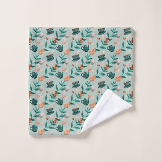 Towels with a teal floral pattern hang  bad handdoek (Wasdoekje)