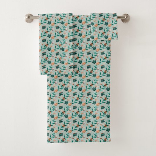 Towels with a teal floral pattern hang  bad handdoek