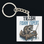 Trash Fishin' Expert Raccoon Sleutelhanger<br><div class="desc">Are you a fan of raccoons and fishing? This funny 'Trash Fishin' Expert' design features a master raccoon angler on a wooden dock with his gear. Perfect for anyone who loves trash panda memes, outdoor fishing trips, and a good laugh. This vintage-style illustration is a great gift for fishers, outdoorsmen,...</div>