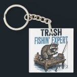 Trash Fishin' Expert Raccoon Sleutelhanger<br><div class="desc">Are you a fan of raccoons and fishing? This funny 'Trash Fishin' Expert' design features a master raccoon angler on a wooden dock with his gear. Perfect for anyone who loves trash panda memes, outdoor fishing trips, and a good laugh. This vintage-style illustration is a great gift for fishers, outdoorsmen,...</div>