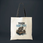 Trash Fishin' Expert Raccoon Tote Bag<br><div class="desc">Are you a fan of raccoons and fishing? This funny 'Trash Fishin' Expert' design features a master raccoon angler on a wooden dock with his gear. Perfect for anyone who loves trash panda memes, outdoor fishing trips, and a good laugh. This vintage-style illustration is a great gift for fishers, outdoorsmen,...</div>