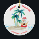 Tropisch Surfende kerstkerst met kerstmis Keramisch Ornament<br><div class="desc">De kerstman neemt een broodnodige vakantie en leeft het goede leven, surft en ontspant op een tropisch eilandstrand. Hij heeft zijn tenen in het zand, een drink in zijn hand, palmbomen en een warme oceaanbries. De groet van de "Warm van de Vergroting"is in een koraalkleur over de bovenkant. Pas uw...</div>