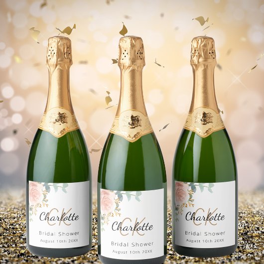 Trouwfeest met bloemig roosgoud monogram sparkling wijnetiket