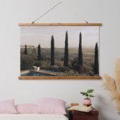 Tuscan landscape hidden behind cypresses (2024) hangend wandkleed (Slaapkamer)