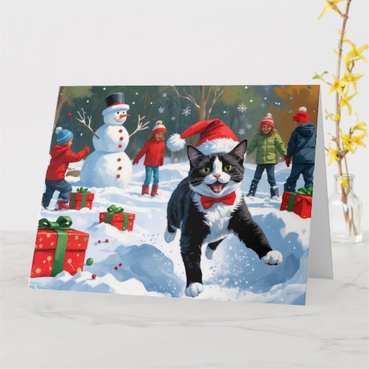 Tuxedo Kat Lopt in Sneeuw met Kerstmuts Kaart (Gele Bloem)