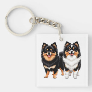 Twee blije pluizige honden zitten naast elkaar sleutelhanger