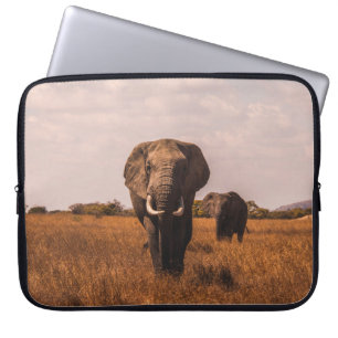 TWEE ELEPHANTS WALKING ON GRASS COVERED GROUND LAPTOP SLEEVE
