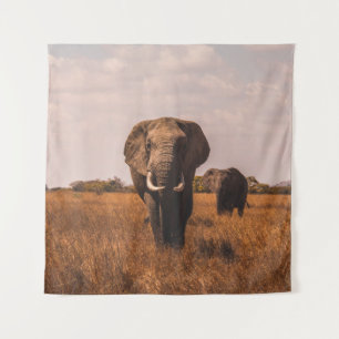 TWEE ELEPHANTS WALKING ON GRASS COVERED GROUND WANDKLEED