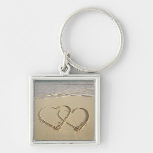 Twee grote harten op het strand met sleutelhanger