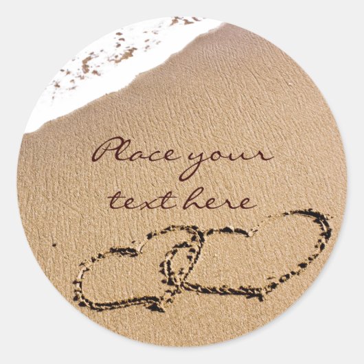 Twee harten in de zand ronde sticker (Voorkant)