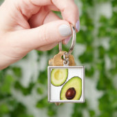 Twee helften van een avocado, wit sleutelhanger (Hand)