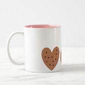 Twee koekjes en melk tweekleurige koffiemok (Links)