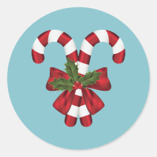 Twee rode en witte snoepstokken op blauw ronde sticker