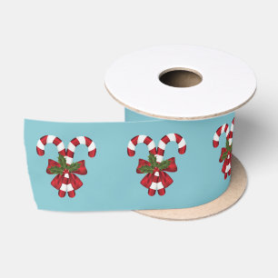 Twee rode en witte snoepstokken op blauw satijnen lint