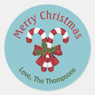 Twee rode en witte snoepstokken op een blauwe acht ronde sticker