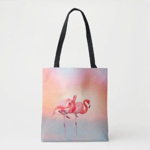Twee roze flamingos in het water bij sunsetflaming tote bag