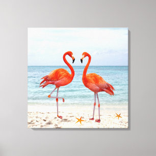 Twee Vibrant Roze Flamingos op het strand Canvas