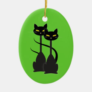 Twee zwarte katten met lange hals op groen keramisch ornament