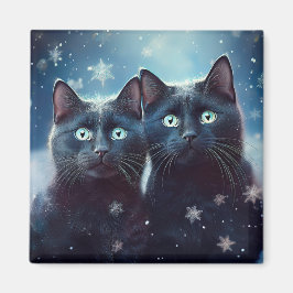 Twee zwarte katten worden besneeuwd magneet