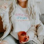 TYRA 90's tropen alsof het heet Bachelorette is T-shirt<br><div class="desc">Dit bachelorette bride shirt heeft een 90's gevatte neonlettertype met de woorden "tropisch als het heet is,  ik steek de knoop vast". Dit shirt paren perfect met de bachelorette "ze bindt de knoop".</div>