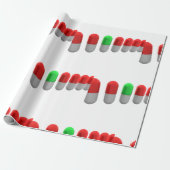 Unieke groene pil tussen rode capsules cadeaupapier (Uitgerold)