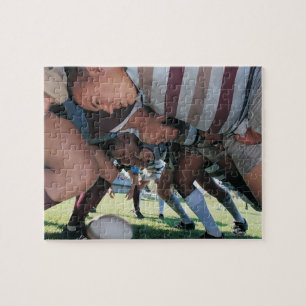 Uniepelaars in rue in een scrum legpuzzel
