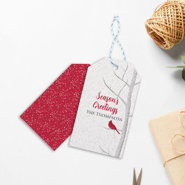 Vakantiegenzegengeveegenboom met rode kardinaal cadeaulabel