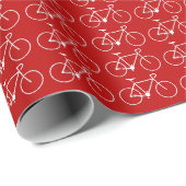Veel witte fietspictogrammen op een rode achtergro cadeaupapier (Rol Hoek)