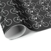 Veel witte fietspictogrammen op een zwarte achterg cadeaupapier (Rol Hoek)