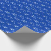 Veel witte fietsvormen op blauw cadeaupapier (Hoek)
