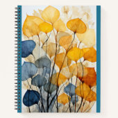 Veelkleurige bladeren op blauw notitieboek (Voorkant)