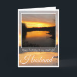 Verjaardag man, Dark Oranje zonsopgang reflectie. Kaart<br><div class="desc">Happy Birthday Husband,  prachtige felle oranje zonsopgang achter gestreepte wolken en duistere bomen,  met oranje en paarse rivierreflectie. Tekst: Gelukkige verjaardag van mijn fantastische man. De binnenste kaart is leeg.</div>