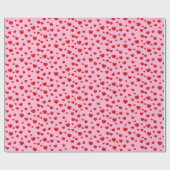 Verspreide rode harten op roze cadeaupapier (Vlak)