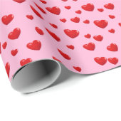 Verspreide rode harten op roze cadeaupapier (Rol Hoek)